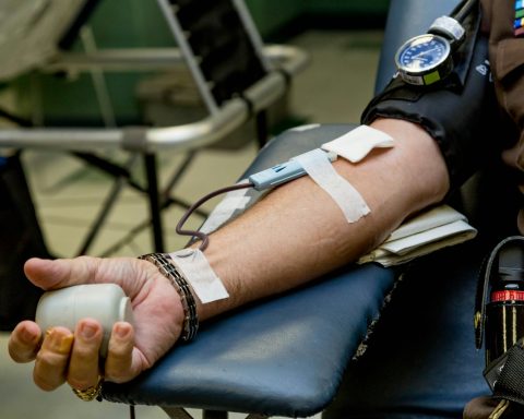 person on chair donating blood