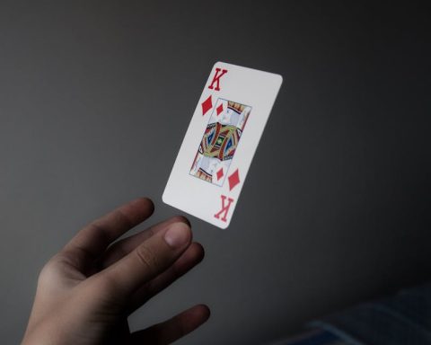 Person Holding King of Diamonds Playing Card