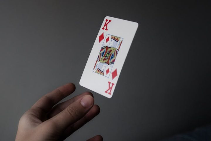 Person Holding King of Diamonds Playing Card