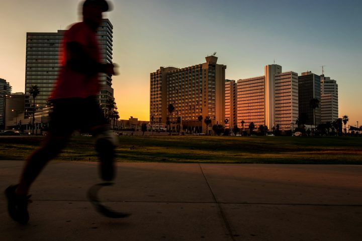 man running on pavement during daytime