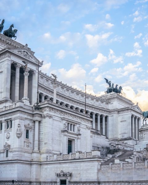 a large building with statues on top of it