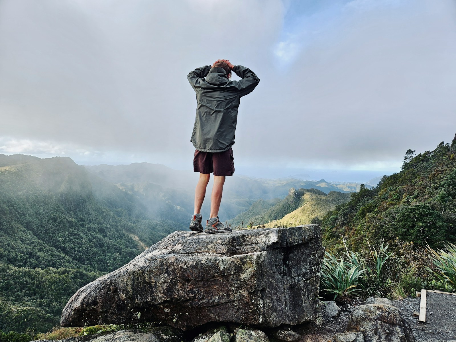 a man standing on top of a large rock