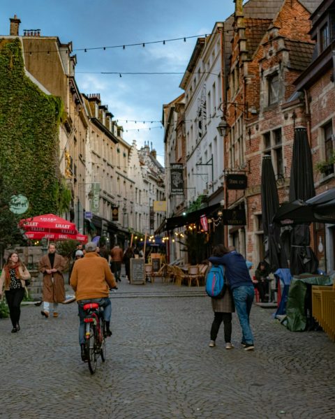 A group of people riding bikes down a street