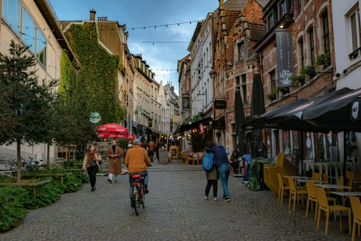 A group of people riding bikes down a street