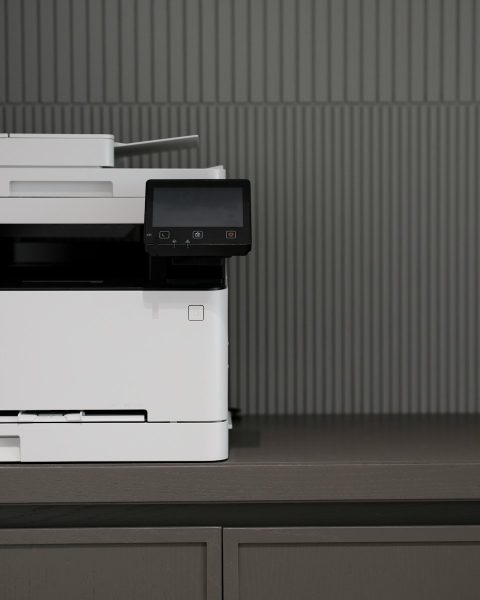 a white and black printer sitting on top of a counter