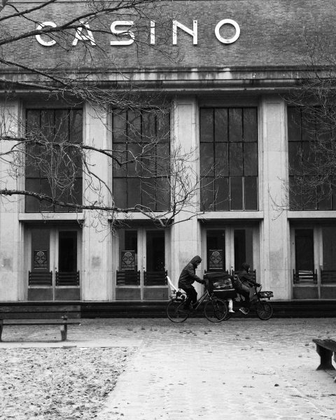 a person sitting on a bench in front of a building