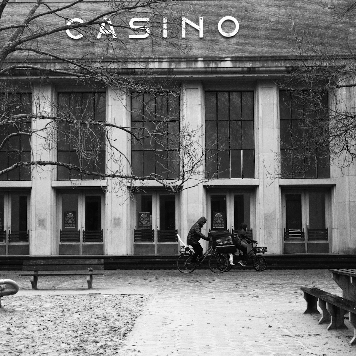 a person sitting on a bench in front of a building