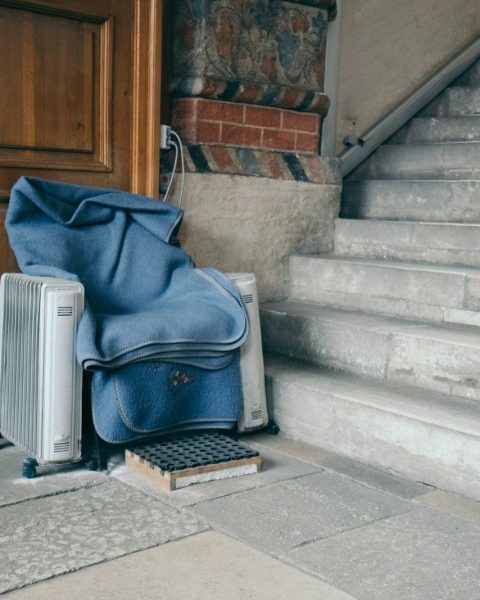 blue and black backpack on gray concrete stairs