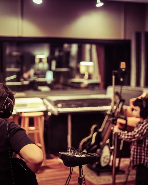 Een Belgische muzikant die aan het opnemen is in een studio
