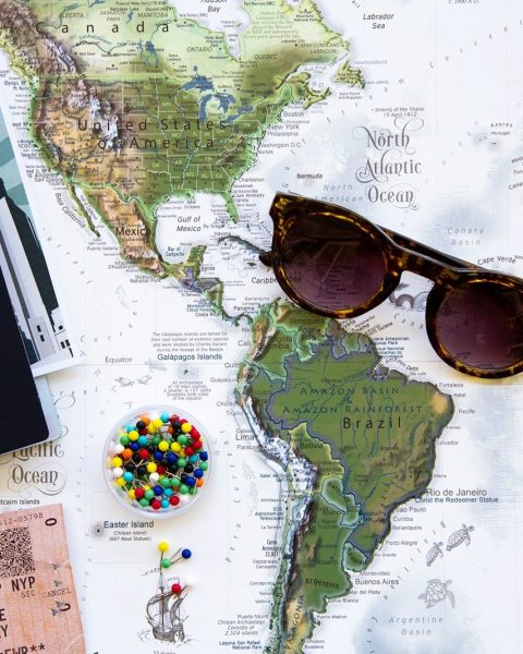 brown framed sunglasses on map